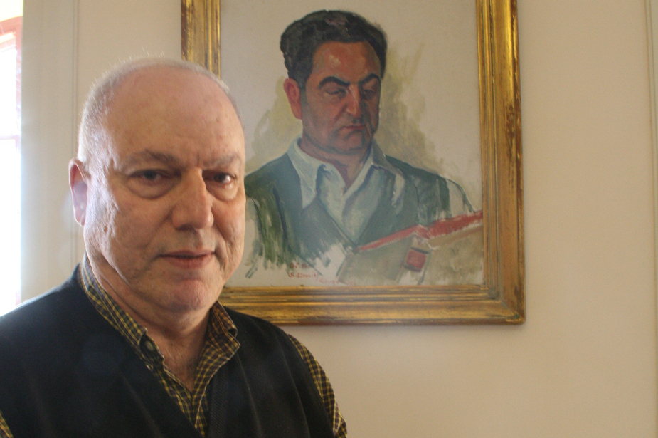 Habib Malik stands next to a portrait of his father, Charles Malik, who was on the UDHR's original drafting committee. © Habib Malik
