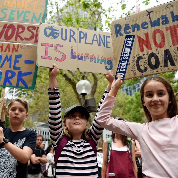 Protesters hold placards during the Climate Crisis National Day of Action rally in Sydney, Australia, 22 February 2020. © EPA-EFE