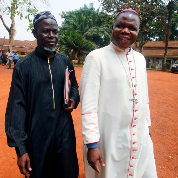 The archbishop of Bangui, Dieudonne Nzapalainga (R) walks with the representant of Bangui's Muslim community, Imam Oumar Kobine Layama (L) after a meeting with senior clerics, peace-keeping troops and people of Bangui, Cental African Republic, 2014. © EPA/Legnan Koula