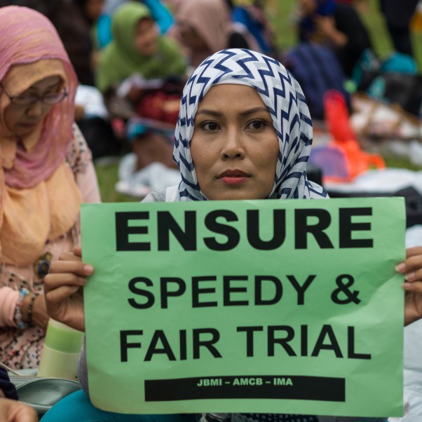 An Indonesia migrant worker holds a sign reading ‘Ensure speedy & fair trial’, Hong Kong, China, 23 October 2016. © EPA/Jerome Favre
