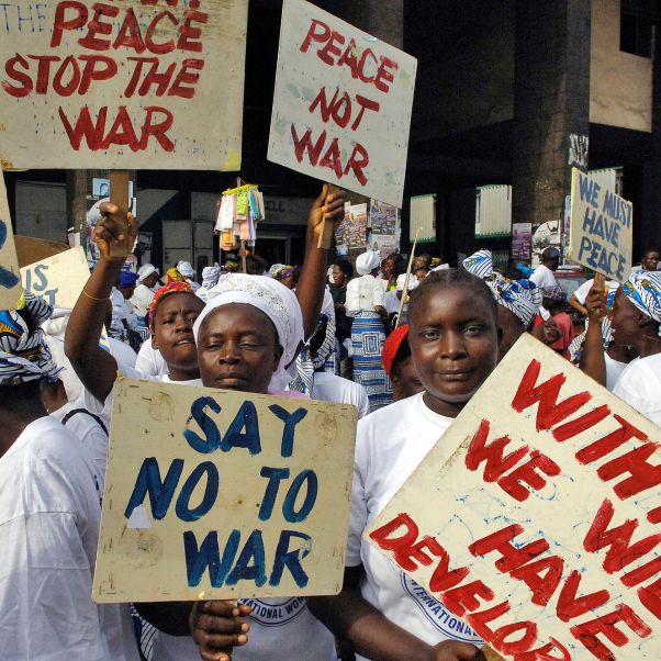 Protesters hold signs calling for peace during a march in observance of International Women's Day, Monrovia, Liberia, 2007. © UN Photo/Eric Kanalstein