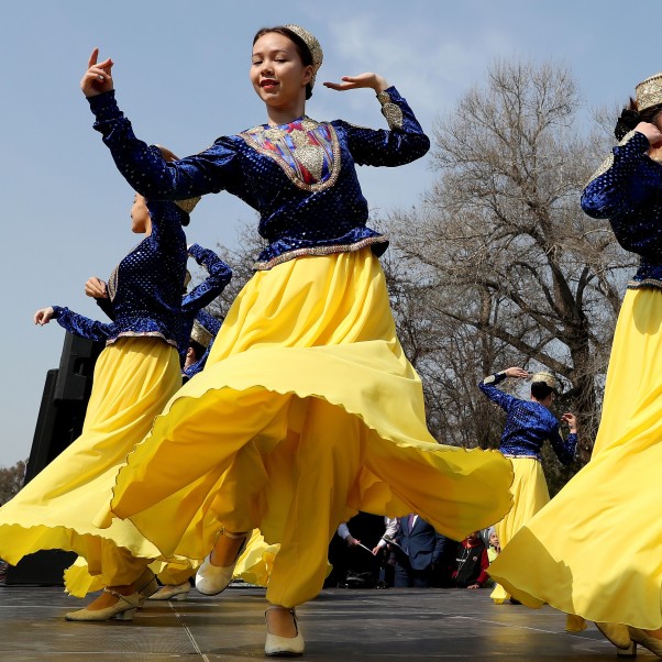 Kyrgyz girls dressed in a national costume dance during the celebration of Nooruz