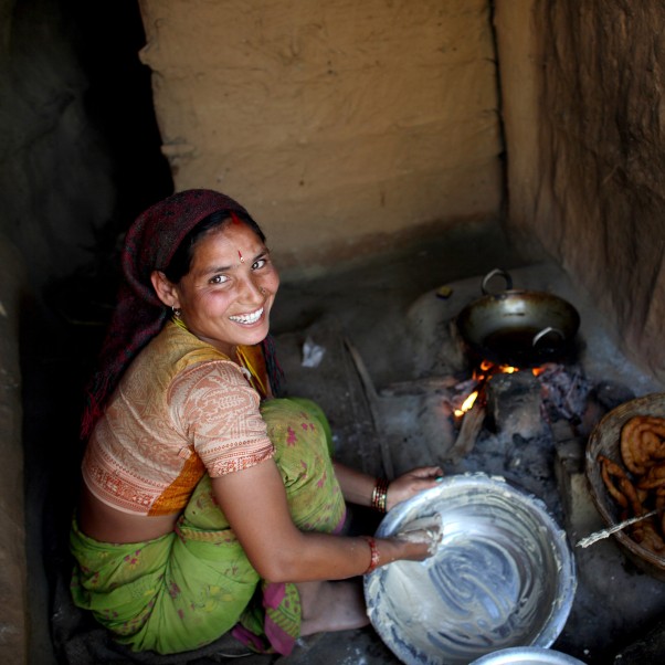 Smiling woman washing a pan