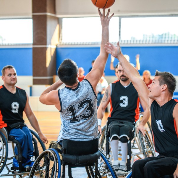 Men on wheelchairs playing basketball