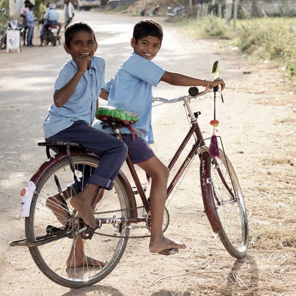 Two children ridding a bike