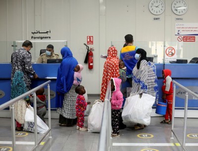 Migrants check in to be deported back to their country at Misrata Airport in Misrata, Libya, November 3, 2021, Reuters
