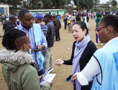 On election day, members of the OHCHR Surge Team engage with human rights defender, Maryanne Kasina, at a polling station in Nairobi. © OHCHR Photo/Stephen Kibunja  