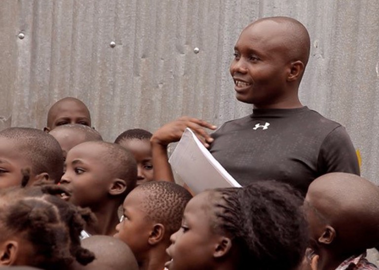 Still of Steve Arodi talking to children in Mathare, Nairobi, Kenya.© Yves Matthey 