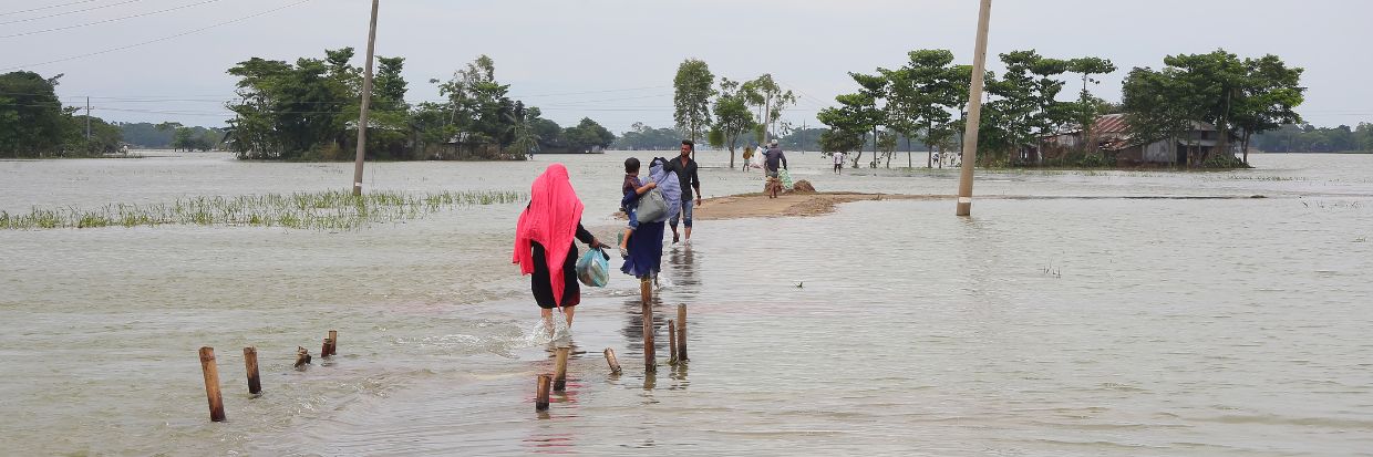 July 21, 2022, Sylhet, Bangladesh: Flood affected people are carry some belongings and move to nearby shelters for greater safety due their homes have been affected by the floods. Credit: Reuters