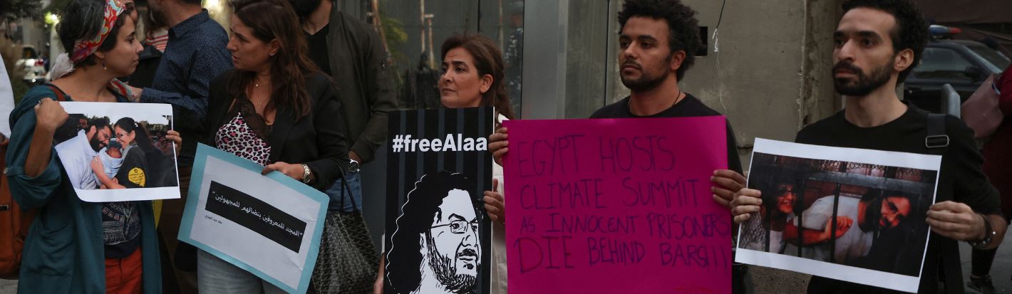 Demonstrators hold signs as they demand the release of Egyptian-British hunger striker Alaa Abd el-Fattah near the British Embassy in Beirut, Lebanon November 7, 2022. © Reuters