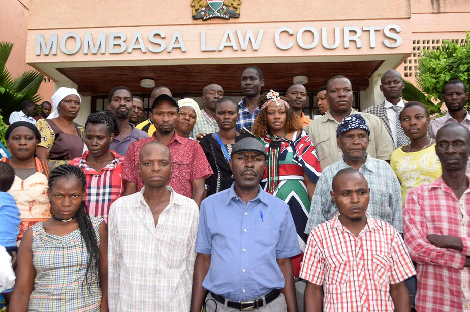 Owino Uhuru settlement residents standing on the steps of the courthouse in Mombasa.