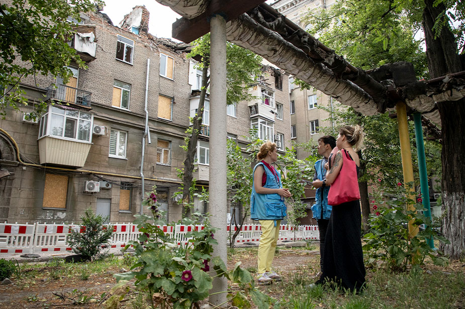 UN Human Rights officers survey damage caused by a missile strike on a residential building in the city of Dnipro. © Vincent Tremeau/OHCHR