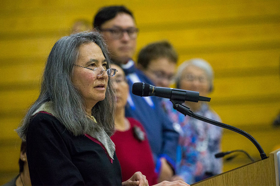 A woman speaking at a podium with a microphone