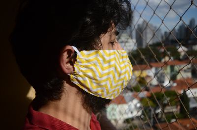 An adolescent boy wearing a protective mask