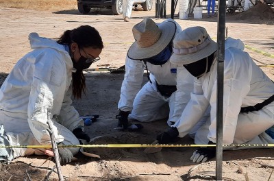 During a visit to Mexico in November 2021, the Committee on Enforced Disappearances accompanied an exhumation with forensic specialists and victims grabbing soil where they located dead bodies. © OHCHR