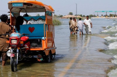 مشرّدون يقفون على طريق سريع غمرته المياه بعد الأمطار والفيضانات خلال موسم الرياح الموسمية في سهوان بباكستان، 16 أيلول/ سبتمبر 2022. © رويترز