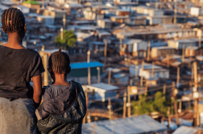 Young girls overlooking Kibera slum in Nairobi, Kenya.