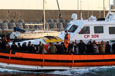 A patrol boat with migrants seen arriving at the port. Nearly 90 migrants, mainly from Afghanistan, Pakistan, and Iran, had been rescued by the Italian Coast Guard and taken at the port of Roccella Jonica “Porto Delle Grazie”. A baby, born three days ago during the crossing, a newborn of 11 days, and a baby of five months were also on board. Members of the Red Cross and Doctors Without Borders and sanitary personnel assisted the babies, their families, and other migrants SOPA Images/Sipa USAValeria Ferraro 