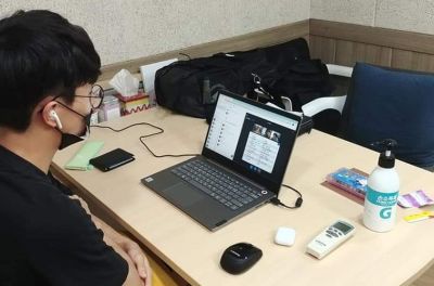 Korean youth looking at laptop