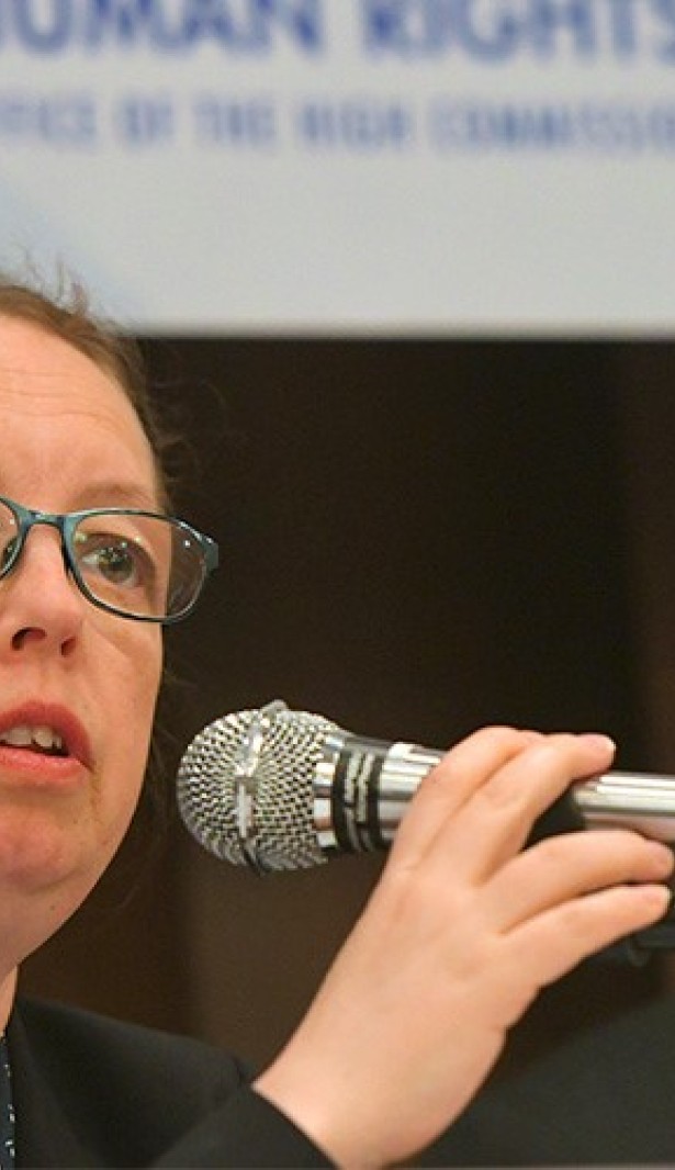 Woman speaking into a microphone