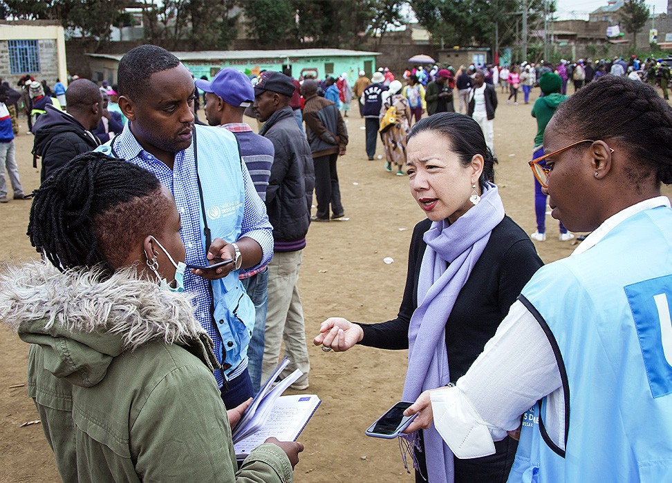 On election day, members of the OHCHR Surge Team engage with human rights defender, Maryanne Kasina, at a polling station in Nairobi. © OHCHR Photo/Stephen Kibunja