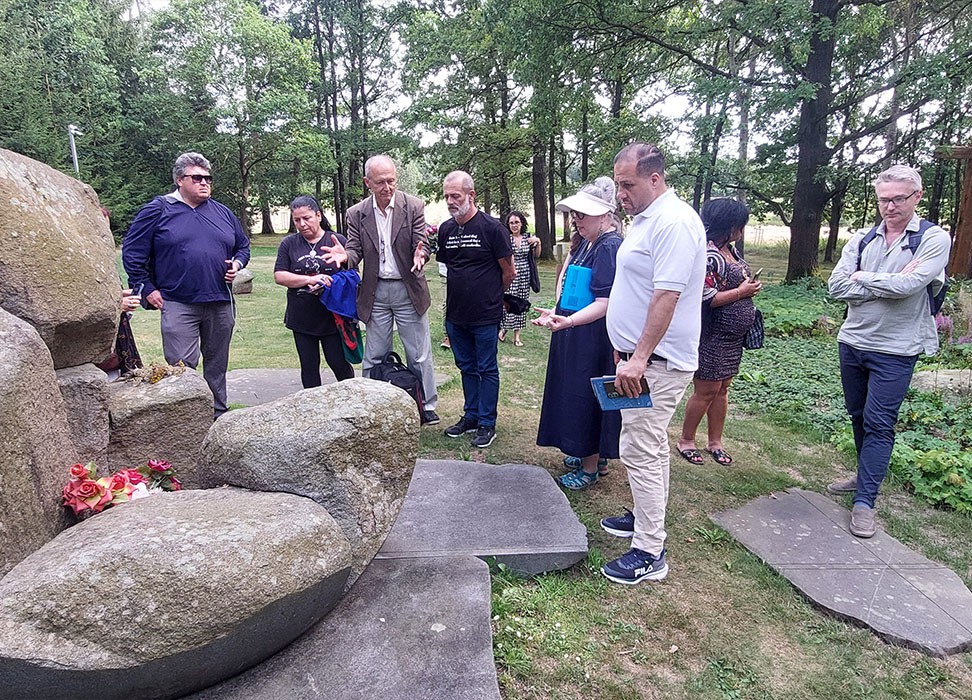 Romani human rights defenders lay flowers at a Romani Holocaust memorial at the newly renovated Lety Roma concentration camp memorial site in Czechia. © Credit – Claude Cahn/OHCHR