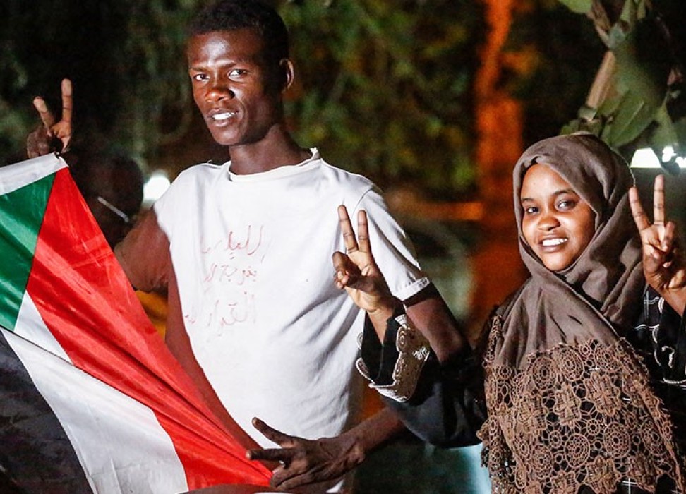 Man and woman with Sudan flag