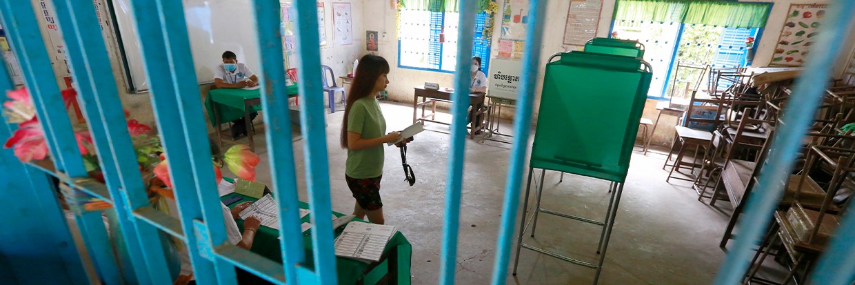2023年7月23日，柬埔寨首都金边的投票处，一名妇女手拿选票走向写票隔间。柬埔寨第七届国民议会选举将于2023年7月23日举行。图片来源：欧新社-埃菲通讯社/KITH SEREY