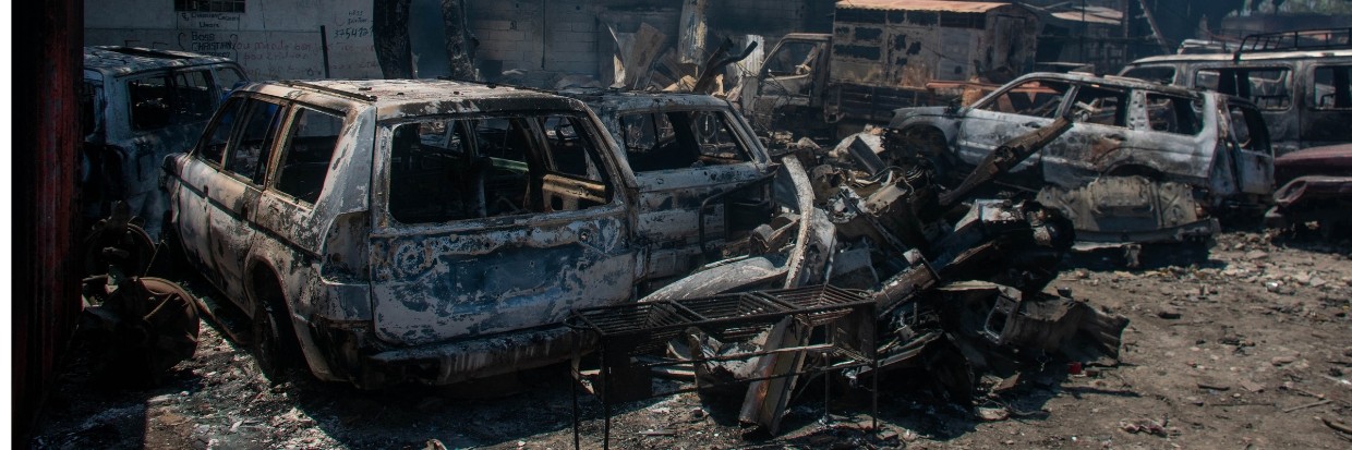 The charred remains of vehicles that were burned near a garage are seen in Port-au-Prince, Haiti, on March 25, 2024. © Clarens SIFFROY / AFP