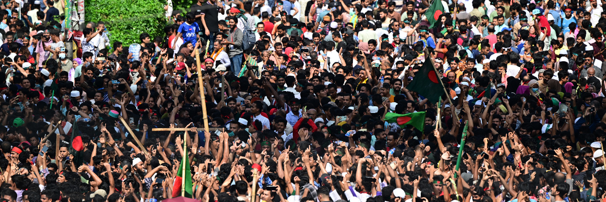 Anti-government protestors celebrate in Shahbag near Dhaka university area in Dhaka on August 5, 2024. Protests in Bangladesh that began as student-led demonstrations against government hiring rules in July culminated on August 5, in the prime minister fleeing and the military announcing it would form an interim government. (Photo by Munir UZ ZAMAN / AFP)