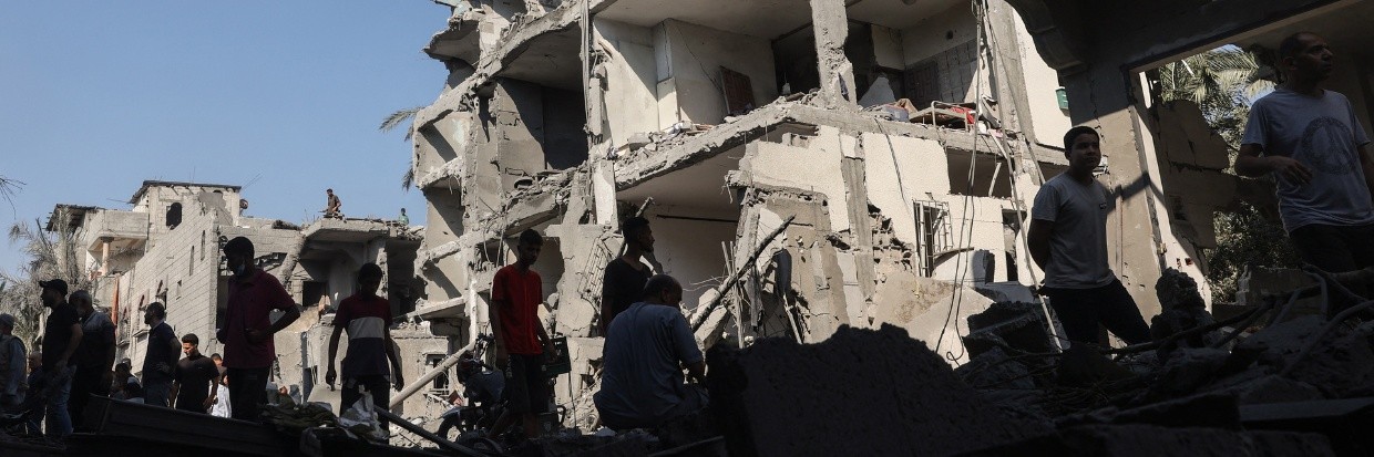 Palestinians check the destruction in Deir el-balah in the central Gaza Strip, on August 7, 2024, following Israeli bombardment amid the ongoing conflict between Israel and the Palestinian Hamas militant group. (Photo by Eyad BABA / AFP)