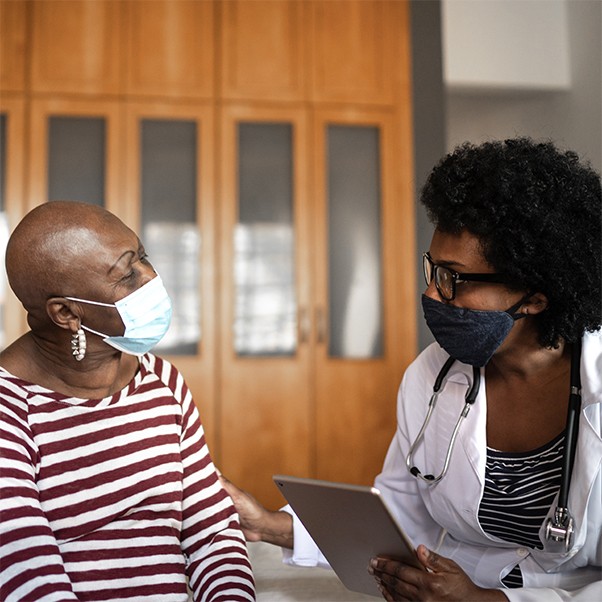 Health visitor and a senior woman during nursing home visit. © FG Trade