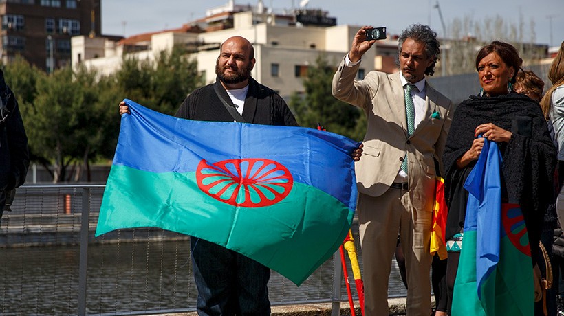several people with the Roma flag