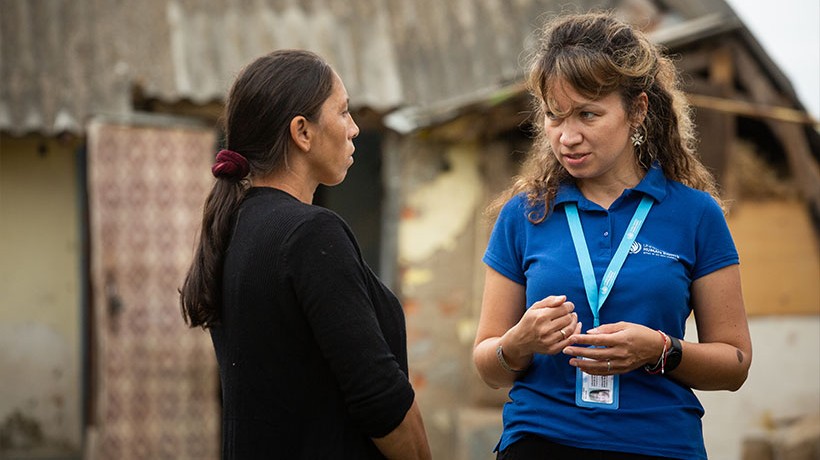 Working closely with communities. Juliana Abramova, Program Manager at UN Human Rights Moldova, with a Roma family. © OHCHR/Vincent Tremeau