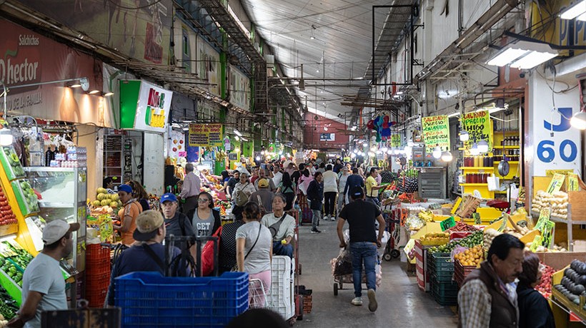 A market aisle full of people and stands.