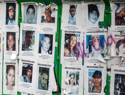 A billboard with photographs of missing persons.