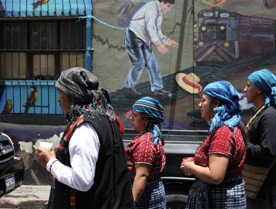 A man and three women hold candles in their hands