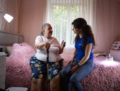 Liubov, a refugee from Ukraine, talks to a UN Human Rights officer in her home in Moldova. © OHCHR/Vincent Tremeau