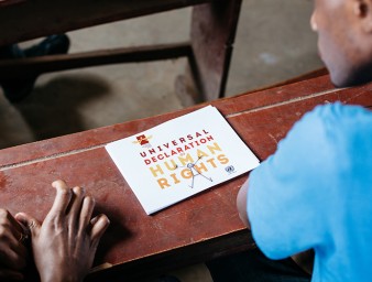 Trainees looking at a copy of the Universal Declaration of Human Rights during a pilot workshop by Education Above All at the Bidi Refugee Settlement in Northern Uganda, March 2019. © Education Above All Foundation/ Paddy Dowling
