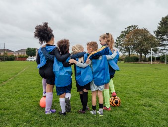 Kids playing football. © Getty  