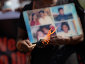 Relatives of the disappeared hold pictures of loved ones during a demonstration.© Kumanan Kanapathippillai