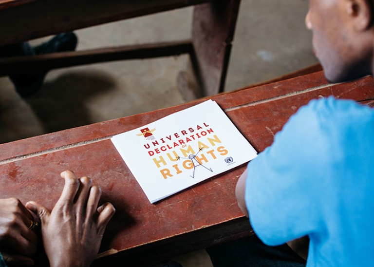 Trainees looking at a copy of the Universal Declaration of Human Rights during a pilot workshop by Education Above All at the Bidi Refugee Settlement in Northern Uganda, March 2019. © Education Above All Foundation/ Paddy Dowling