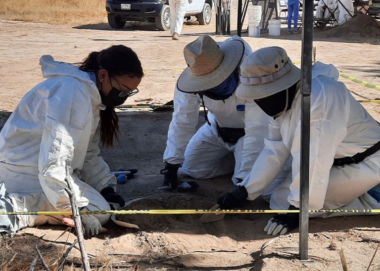 During a visit to Mexico in November 2021, the Committee on Enforced Disappearances accompanied an exhumation with forensic specialists and victims grabbing soil where they located dead bodies. © OHCHR