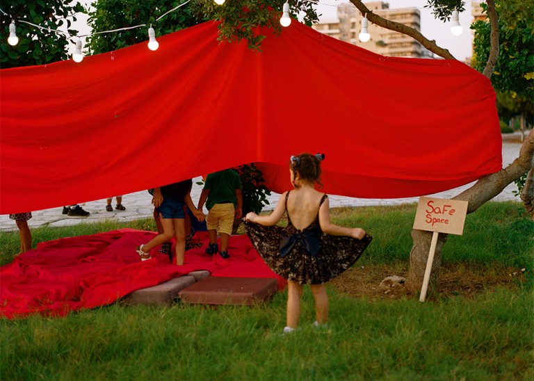 A little girl playing in front of our "safe space" in Tripoli, Lebanon, the first location of the Jeyetna mobile festival in July 2021. During the Jeyetna events women can participate in discussion circles where all women and people who menstruate can share their experiences and voice their opinions in a free and non-judgemental environment. © Evelina Llewellyn